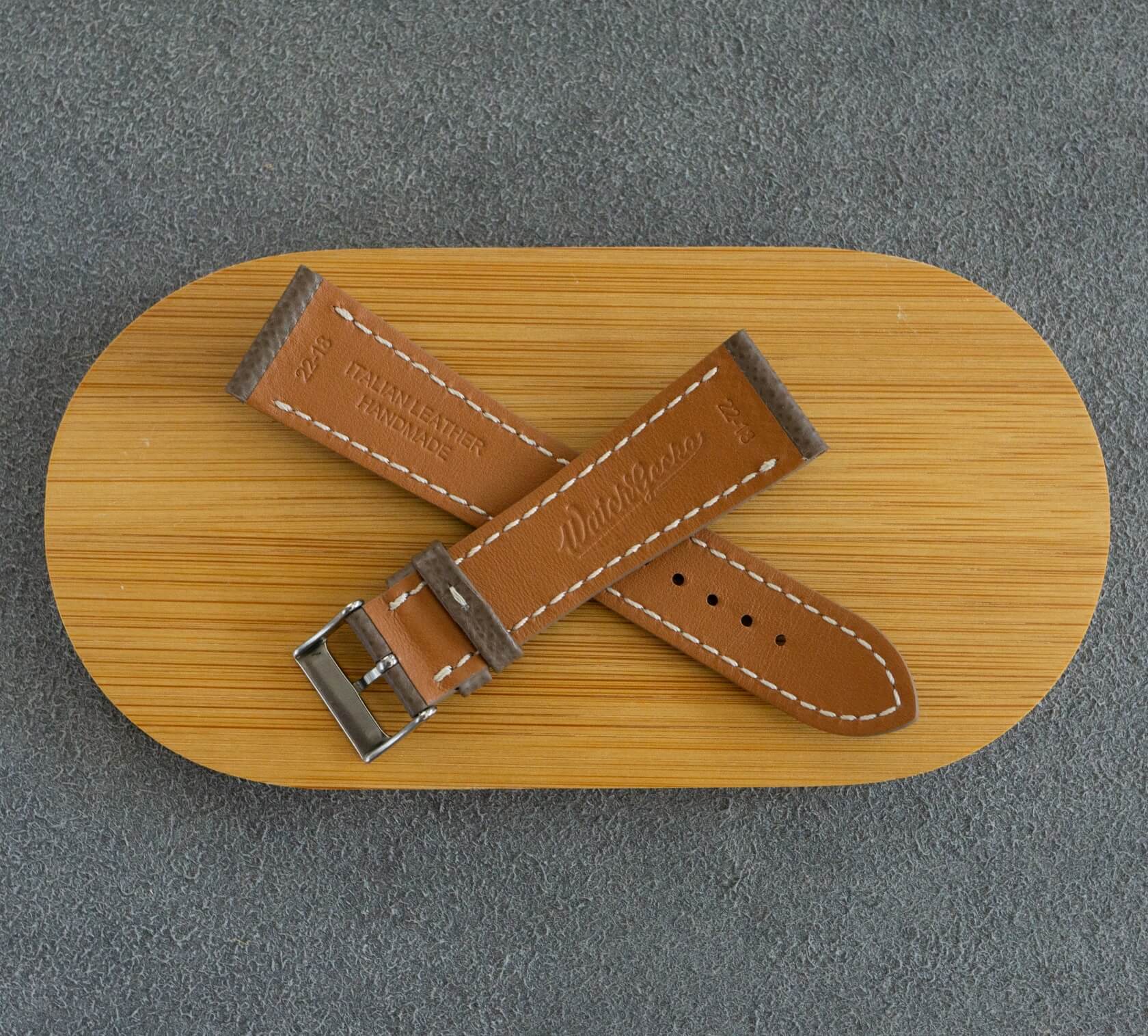 The underside of the strap is lined using honey-colored calf leather